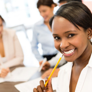 Successful black business woman at the office looking very happy